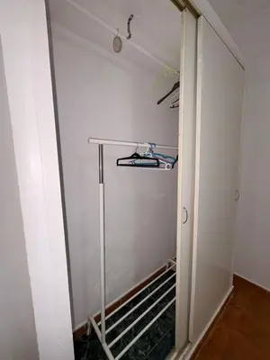 a walk in closet with a white wall at Casa Antonia II in Jerez de la Frontera