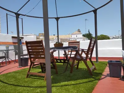 a patio with a table and chairs under a tent at Apartamento EG17 in Arcos de la Frontera