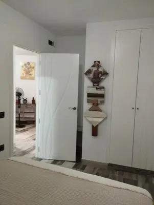a bedroom with a bed and a white closet at Apartamento EG17 in Arcos de la Frontera