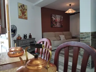 a living room with a tea pot and two chairs at Apartamento EG17 in Arcos de la Frontera