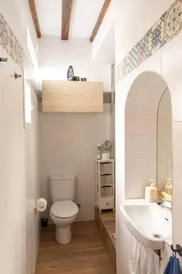 a white bathroom with a toilet and a sink at Columela by Gades Gestión in Cádiz