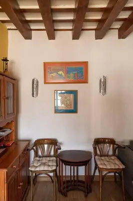 a kitchen with three chairs and a table in a room at Columela by Gades Gestión in Cádiz