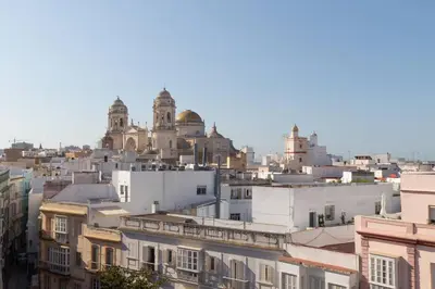 a city skyline with buildings and domes in the background at Columela by Gades Gestión in Cádiz