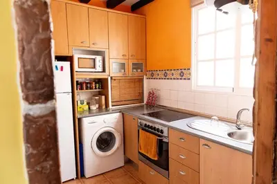 a kitchen with a washing machine and a sink at Columela by Gades Gestión in Cádiz