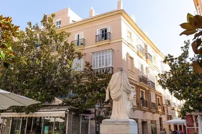 a statue of a woman in front of a building at Columela by Gades Gestión in Cádiz