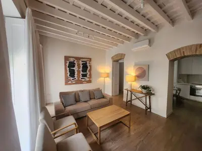 a living room with a couch and a table at Apartamento Ancha 3 in Sanlúcar de Barrameda