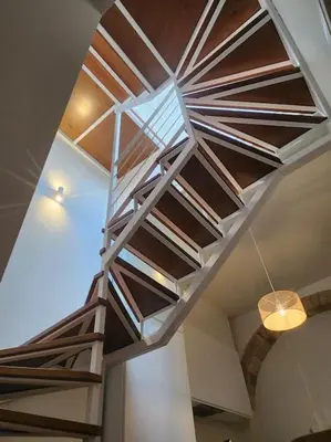 a wooden staircase in a room with a ceiling at Apartamento Ancha 3 in Sanlúcar de Barrameda