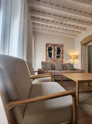 a living room with two couches and a table at Apartamento Ancha 3 in Sanlúcar de Barrameda