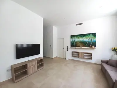 a living room with a couch and a flat screen tv at Dani Home in Cádiz