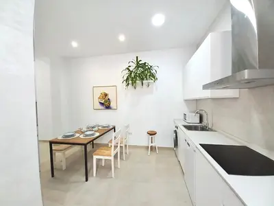 a kitchen and dining room with a table and chairs at Dani Home in Cádiz
