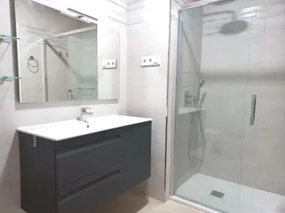 a bathroom with a sink and a shower at Dani Home in Cádiz