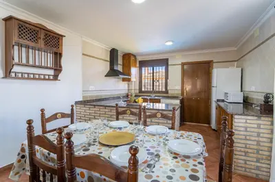 a kitchen with a table with plates on it at EntreCalas 4 Chalet con piscina privada en Conil, cala aceite, Roche viejo in Conil de la Frontera