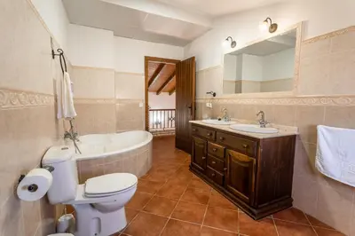 a bathroom with a toilet and a tub and a sink at EntreCalas 4 Chalet con piscina privada en Conil, cala aceite, Roche viejo in Conil de la Frontera