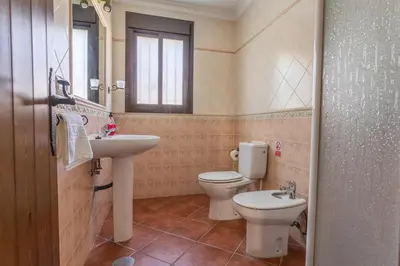 a bathroom with a sink and a toilet and a window at EntreCalas 4 Chalet con piscina privada en Conil, cala aceite, Roche viejo in Conil de la Frontera
