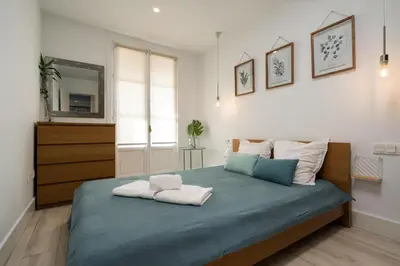 a bedroom with a bed with two towels on it at Apartoyou - Polvorista Puerto in El Puerto de Santa María