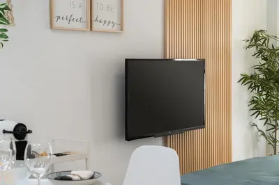 a flat screen tv hanging on a wall at Apartoyou - Polvorista Puerto in El Puerto de Santa María