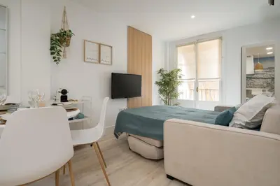 a bedroom with a bed and a table and a couch at Apartoyou - Polvorista Puerto in El Puerto de Santa María