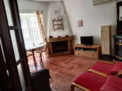 a living room with a couch and a fireplace at Chalet Aquí No Es in Chiclana de la Frontera