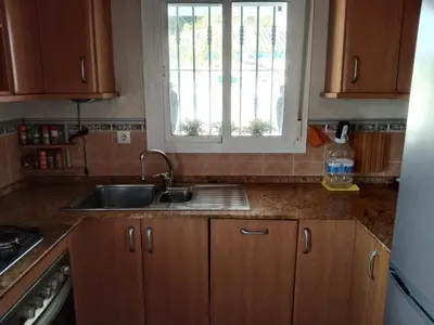 a kitchen counter with a sink and a window at Chalet Aquí No Es in Chiclana de la Frontera