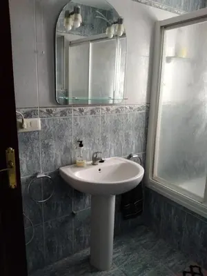 a bathroom with a white sink and a mirror at Chalet Aquí No Es in Chiclana de la Frontera