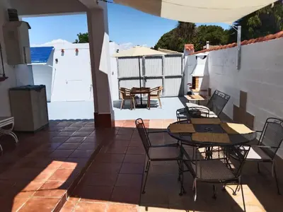 a patio with a table and chairs on a patio at Chalet Aquí No Es in Chiclana de la Frontera