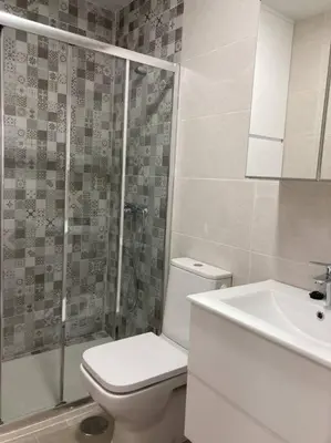 a bathroom with a toilet and a shower and a sink at Apartamento Rota Progreso 5 in Rota