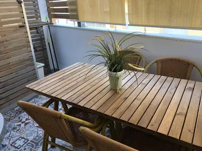 a wooden table with a potted plant sitting on it at Apartamento Rota Progreso 5 in Rota