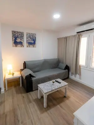 a living room with a couch and a coffee table at SH Loft del Mar. Cerca de la playa y el centro. AC in Cádiz