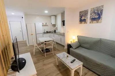 a living room with a couch and a table at SH Loft del Mar. Cerca de la playa y el centro. AC in Cádiz