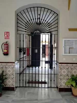 a black iron gate in a room with at Apartamento las tres lunas in Sanlúcar de Barrameda