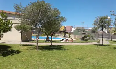 a park with a swimming pool and some trees at RESIDENCIAL EN BAJO DE GUIA in Sanlúcar de Barrameda