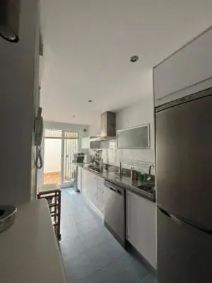 a kitchen with a refrigerator and a counter top at RESIDENCIAL EN BAJO DE GUIA in Sanlúcar de Barrameda