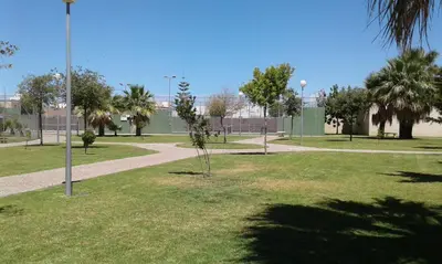 a park with trees and a path in the grass at RESIDENCIAL EN BAJO DE GUIA in Sanlúcar de Barrameda