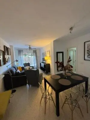 a living room with a table and a couch at RESIDENCIAL EN BAJO DE GUIA in Sanlúcar de Barrameda