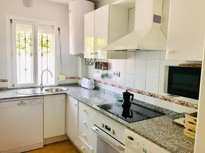 a kitchen with a sink and a counter top at Apartamento con porche y piscina in Chiclana de la Frontera