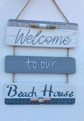two signs that say welcome to our beach house at Apartamento con porche y piscina in Chiclana de la Frontera