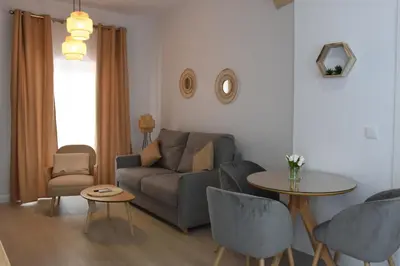 a living room with a couch and a table at CAPILLITA XXI APARTAMENTOS in Sanlúcar de Barrameda