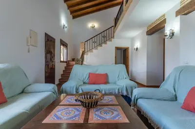a living room with two blue couches and a table at EntreCalas 3 chalet piscina privada Conil, Roche Viejo, Cala del Aceite in Conil de la Frontera