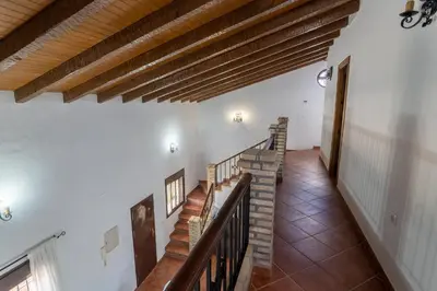 a staircase in a house with wooden beams at EntreCalas 3 chalet piscina privada Conil, Roche Viejo, Cala del Aceite in Conil de la Frontera