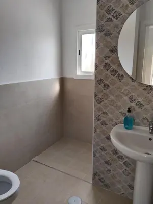 a bathroom with a sink and a toilet and a mirror at Casa EDU in Sanlúcar de Barrameda