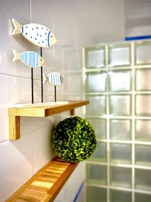three fish figurines on a shelf in a bathroom at MyChoice Marina in Rota