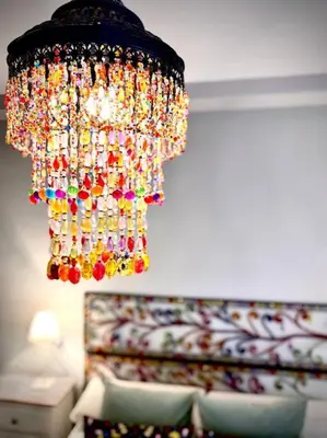a colorful chandelier hanging over a couch at MyChoice Marina in Rota
