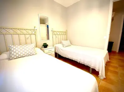 a bedroom with two beds and a mirror at MyChoice Marina in Rota