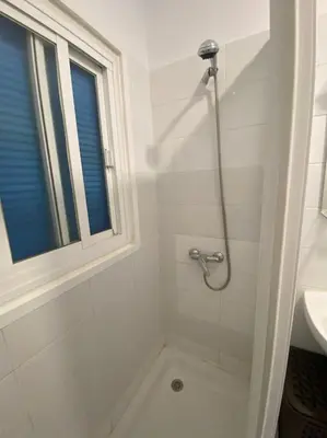a white bathroom with a shower and a sink at Cozy Apartment in Chiclana City Center by Chiclana Dreams in Chiclana de la Frontera