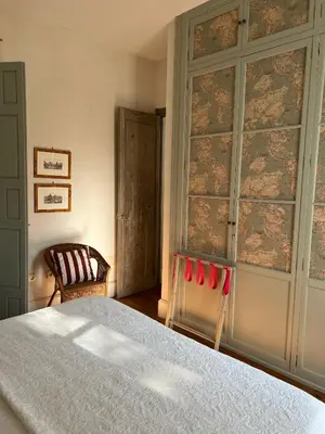 a bedroom with a bed and a wall with a window at CASA PALACIO LAS MARÍAS - Casa en exclusividad in Cádiz
