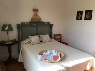 a bedroom with a bed with a basket on it at CASA PALACIO LAS MARÍAS - Casa en exclusividad in Cádiz