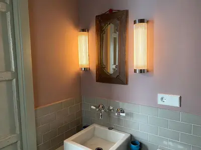 a bathroom with a sink and a mirror and lights at CASA PALACIO LAS MARÍAS - Casa en exclusividad in Cádiz