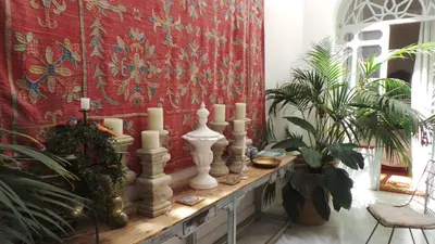 a room with a table with candles and plants at CASA PALACIO LAS MARÍAS - Casa en exclusividad in Cádiz