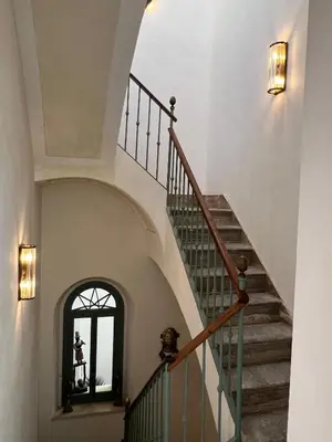 a staircase in a house with a stair case at CASA PALACIO LAS MARÍAS - Casa en exclusividad in Cádiz