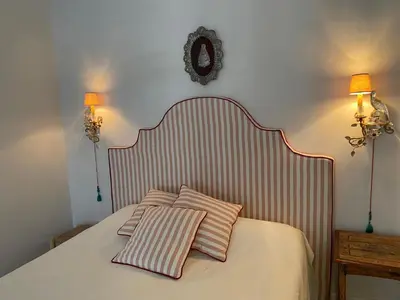 a bedroom with a bed with two pillows on it at CASA PALACIO LAS MARÍAS - Casa en exclusividad in Cádiz
